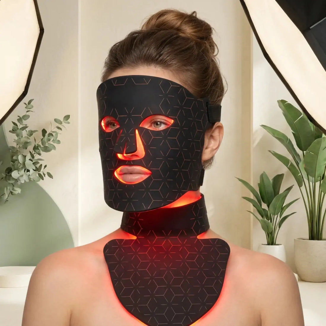 Woman using an LED light therapy mask correctly at home