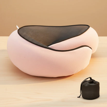 Pink massage chair with black mesh backrest on a wooden surface