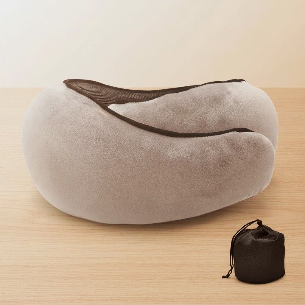 Gray neck pillow with black mesh on a wooden surface, accompanied by a black carrying bag.