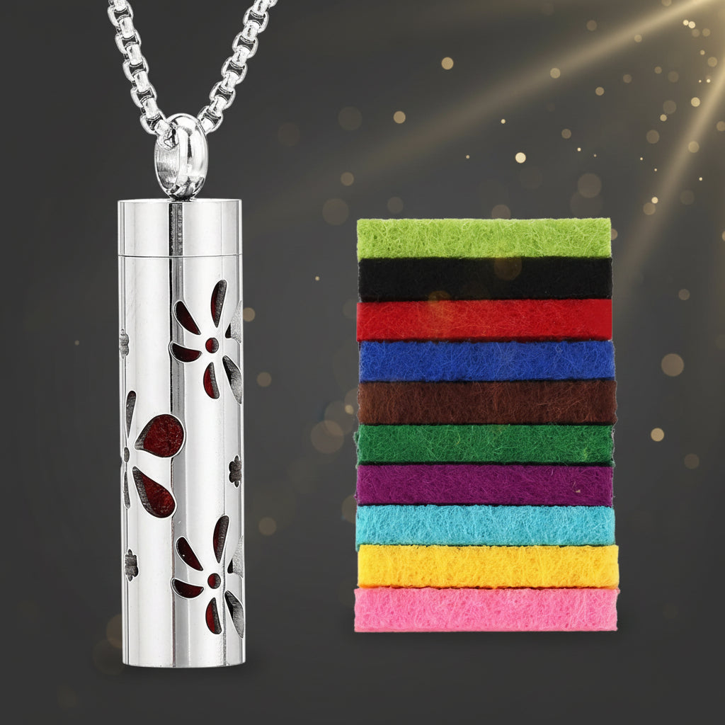 Silver cylindrical pendant with floral designs next to a rectangular strip of colorful fabric on a white background