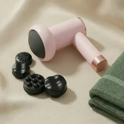 Pink handheld device with black attachments on a beige surface with a green towel.