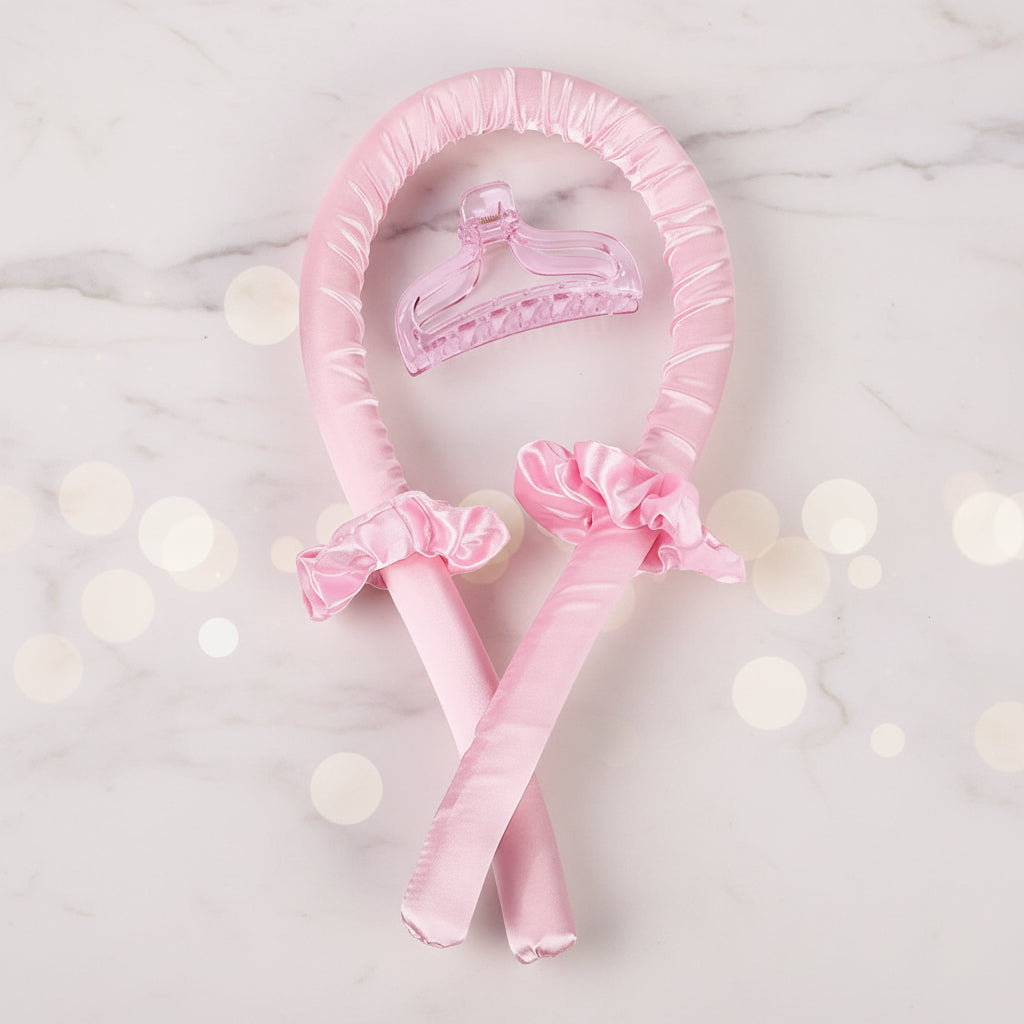 Pink satin headband with decorative bows on a white background