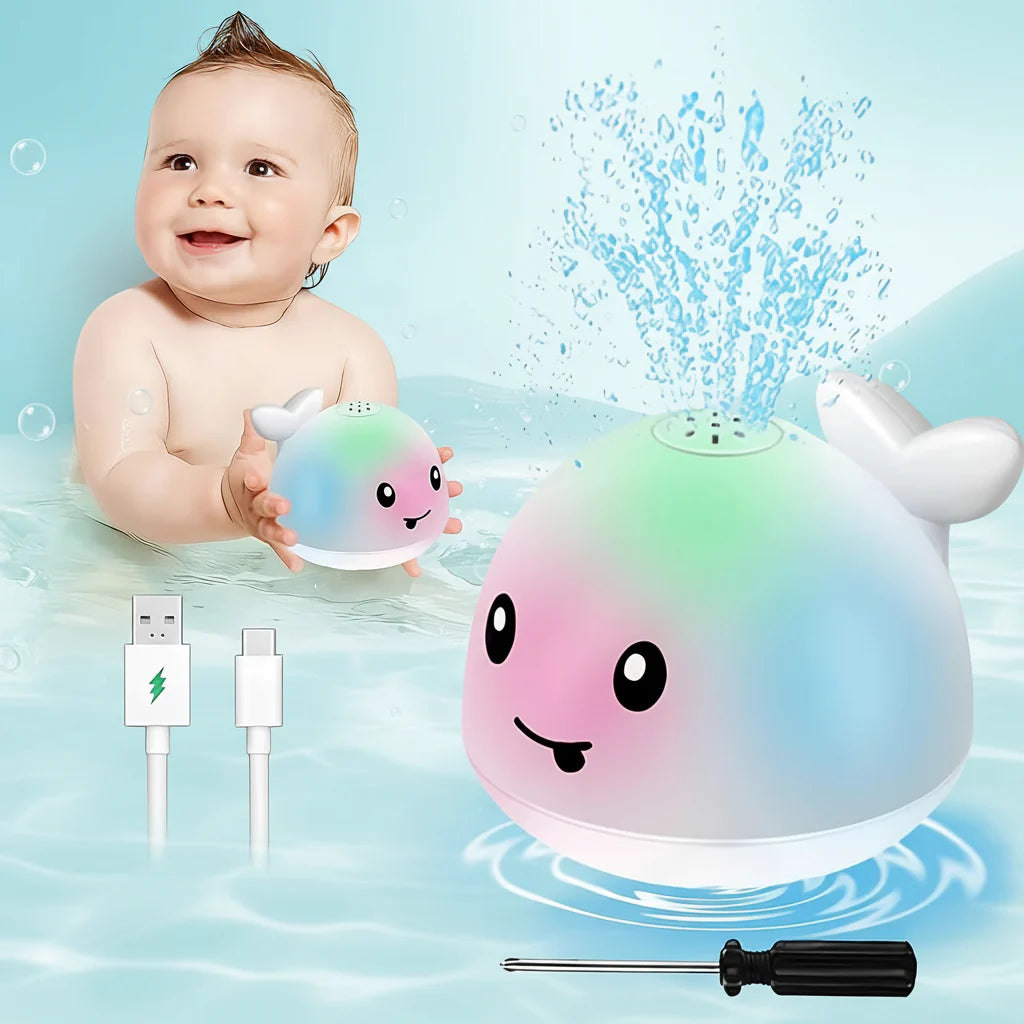 Baby playing with a colorful bath toy shaped like a whale, with water splashing around it.