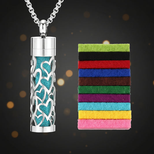 Cylindrical metal urn with decorative heart patterns on a white background, accompanied by a colorful striped card.