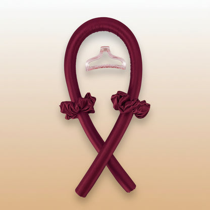 Two maroon hangers with floral attachments on a white background