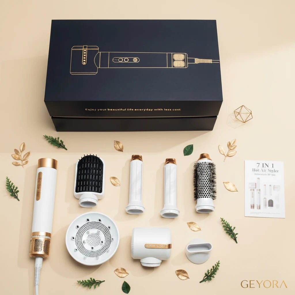 Set of hair styling tools including a hair dryer, attachments, and a branded box on a marble surface.