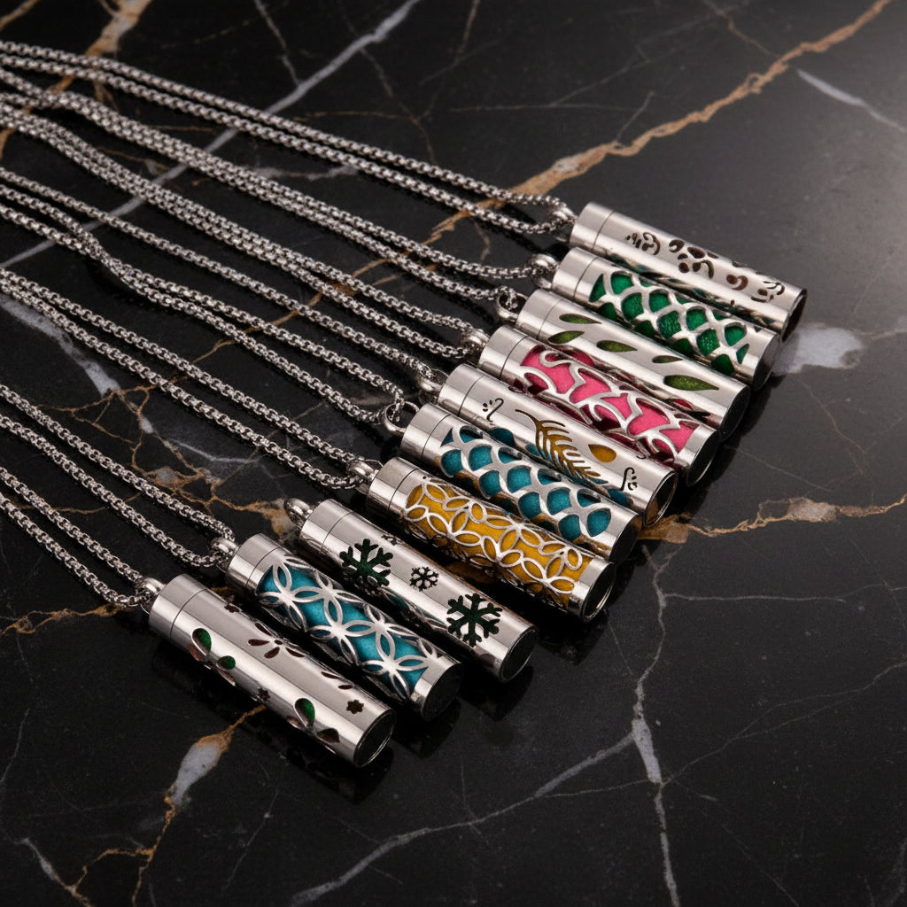 Silver necklaces with various designs on a wooden surface