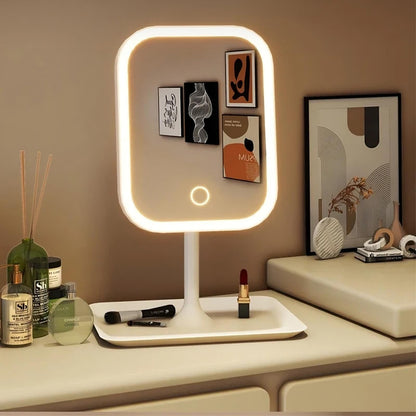 Lighted vanity mirror on a dresser with various items including a bottle, diffuser, and makeup.