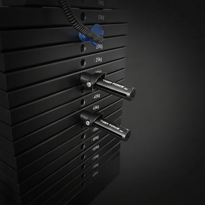 Stack of weight plates on a weight rack with visible brand name.