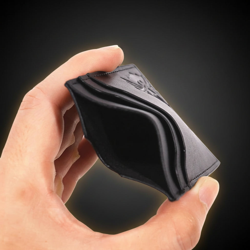 Hand holding a black leather wallet against a white background