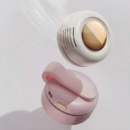 Pink and white earbuds with gold accents on a light gray background