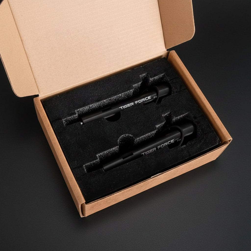 Two black tools labeled 'Tiger Force' in an open cardboard box on a textured surface.