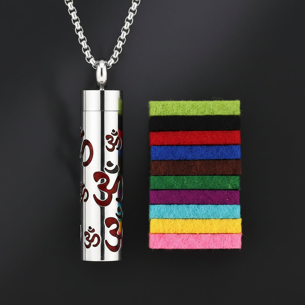 Silver pendant with Om symbol and colorful felt pads on a white background