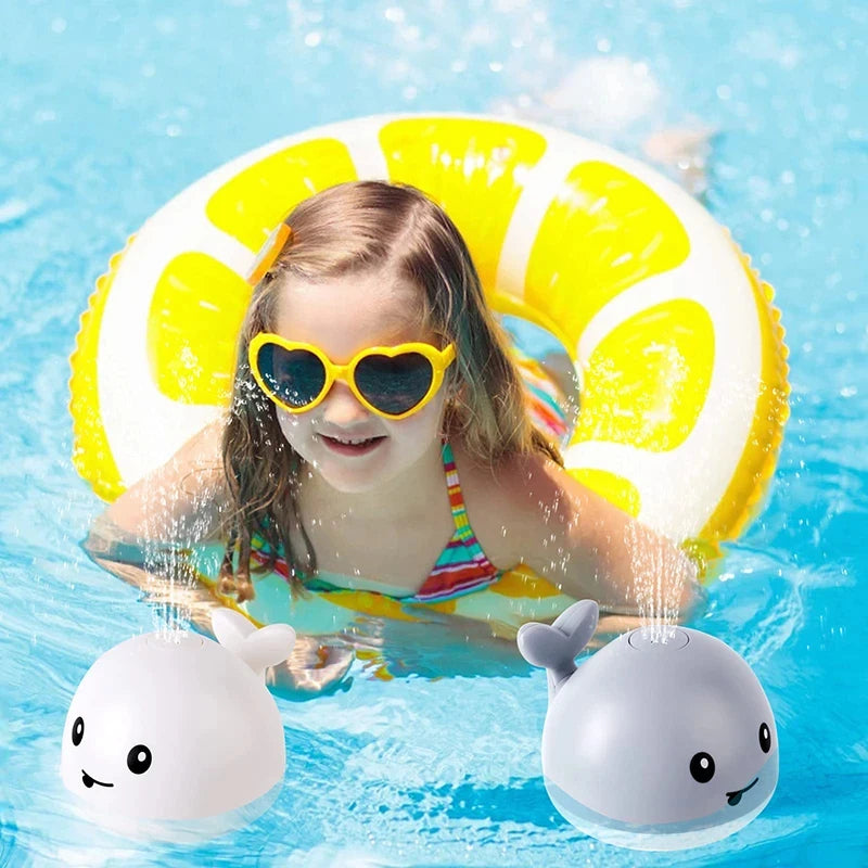 Child in a pool with a yellow inflatable ring and two whale-shaped toys.