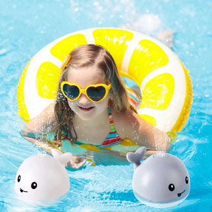 Child in a pool with a yellow inflatable ring and two whale-shaped toys.