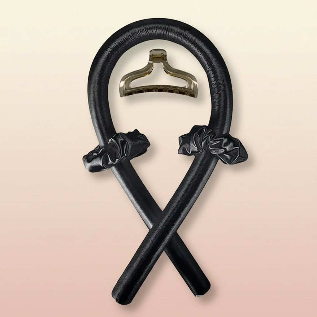 Decorative black metal object with a central hanger on a white background