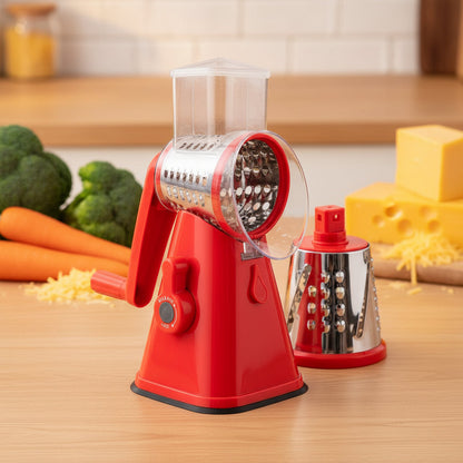 Red manual grater with interchangeable metal grating drums on a white background