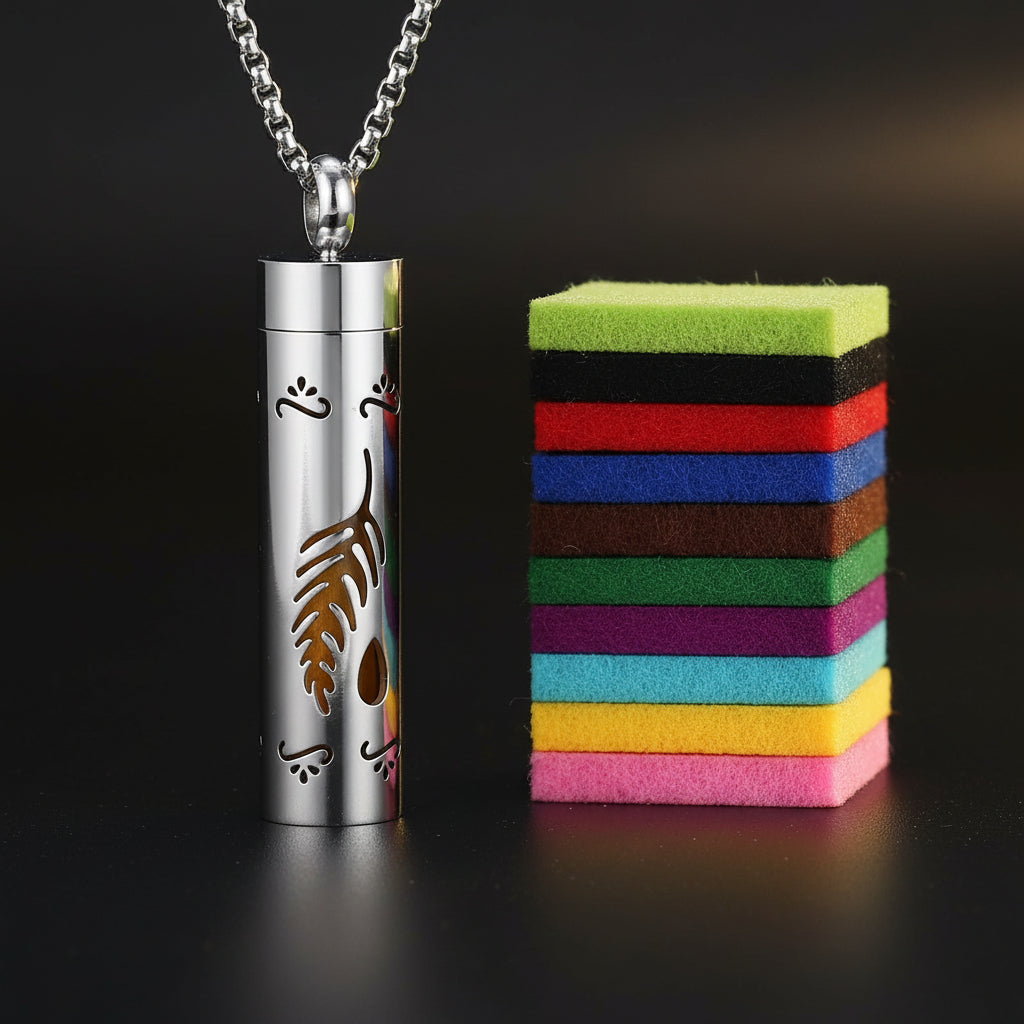 Silver cylindrical pendant with feather design and colorful felt strips on a white background