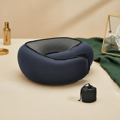 Blue neck pillow with carrying bag on a beige surface